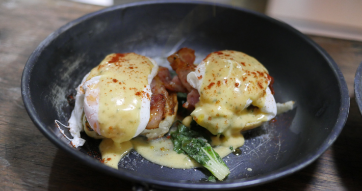 Image of Eggs Benedict plated elegantly at BLISS Restaurant Siargao, showcasing culinary excellence and local island flavor.