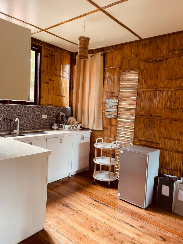 Image showcasing a fully equipped kitchen at BlissBamboo Family Homes on Siargao, perfect for preparing home-cooked meals.