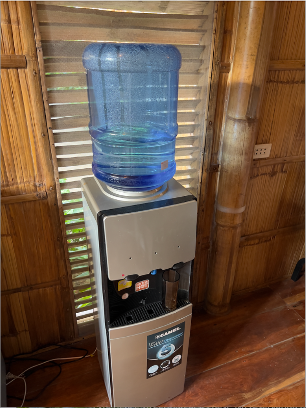 Image featuring an inclusive water dispenser at BlissBamboo Homestay on Siargao, ensuring guests stay well-hydrated.