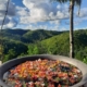 Kawa Hot Bath at Canijugan Peak: A unique and relaxing experience where visitors can unwind in a large, traditional Filipino cauldron bath surrounded by the natural beauty of Siargao's lush landscape.